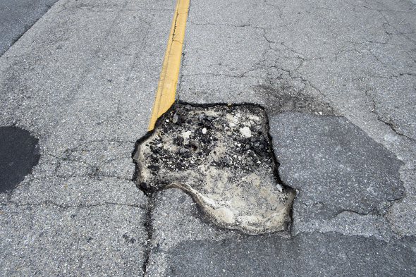 Damaged Asphalt Road With Deep Pothole On American Highway Surface ...