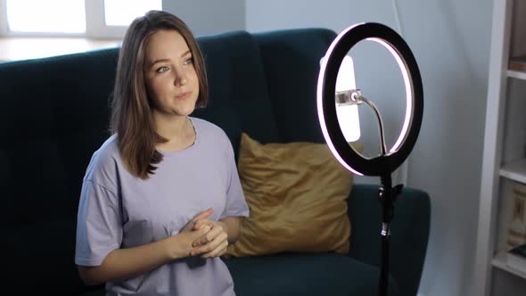Woman Blogger Is Recording Video Shooting Story on Smartphone Using Ring Lamp