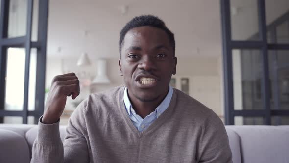 Happy African Young Man Talking Looking at Camera Video Calling at Home alt