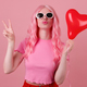 Fashionable woman, total pink, peace hand, with balloon excited having fun enjoying, entertainment.  - PhotoDune Item for Sale