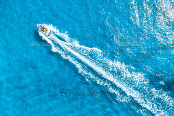 Aerial view on fast boat on azure Mediterranean sea at sunny day. Fast ship on the sea surface.