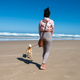 Woman seen walking her dog with a leash along the beach - PhotoDune Item for Sale