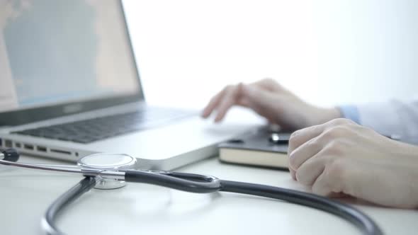 Doctor Working With Laptop alt