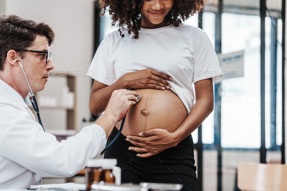 Male gynecologist doctor checking african american pregnant woman, Gynecology Consultation concept
