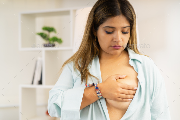 Woman touching his breast to control and prevent cancer