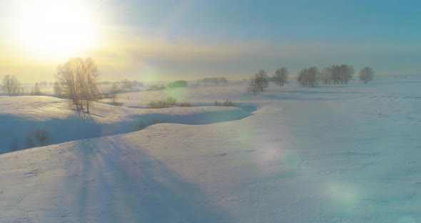 Aerial View of Cold Winter Landscape Arctic Field Trees Covered with Frost Snow Ice River and Sun alt