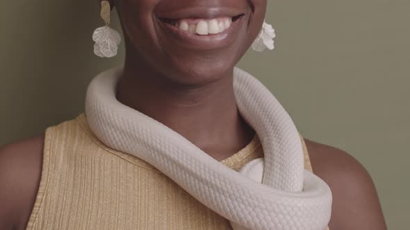 Portrait of Young Black Woman with White Rat Snack around Her Neck alt
