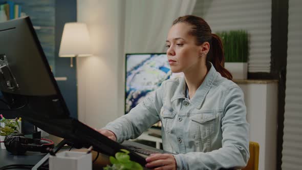 Graphic Designer Using Photography Equipment for Retouch Work alt