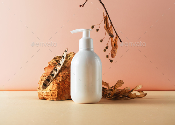 Bottle with pump and brick and natural plant parts creative still life cosmetic photography