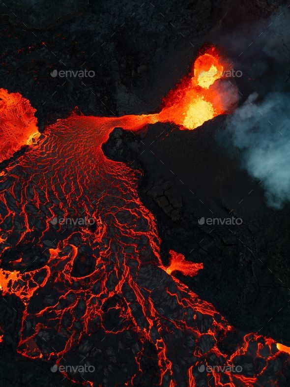 Vertical shot of lava flowing over rocky surface during 2022 Meradalir ...