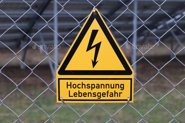 Electric German sign for high voltage risk of death at a mesh wire fence