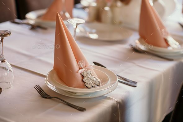 Closeup shot of table setting with paper napkins and wooden bear decor