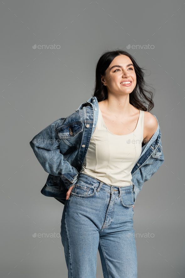 Portrait young woman wearing denim jacket and jeans - Stock Image