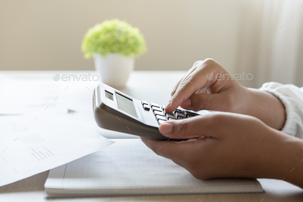 Woman calculate bill budget payment, home accounting concept with calculator.