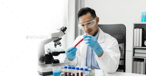 Lab work, Doctor holds a test tube takes the test from a test tube in analysis.