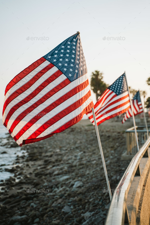 Vertical shot of waving American Flags waving on the beach of Ventura, California