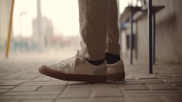 Travel Man Sitting On Bench Tram Station And Moving Legs. Businessman Nervous Stomping Legs. alt