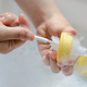 Washing baby nipples. Mother's hand washing the baby nipples Stock