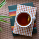 Top view of a cup of hot tea and books - PhotoDune Item for Sale