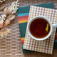 Selective focus closeup of hot tea and books - PhotoDune Item for Sale