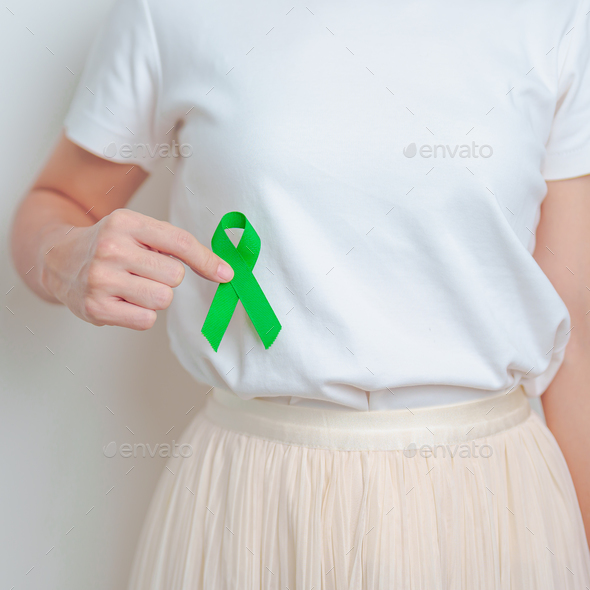 Woman having liver pain with green ribbon. Liver Cancer