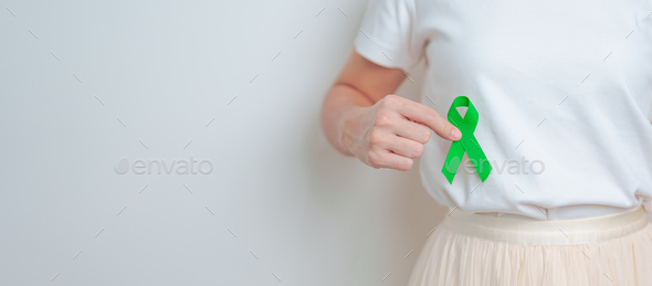 Woman having liver pain with green ribbon. Liver Cancer