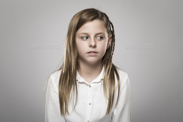 Studio portrait of a pretty girl looking askance - Stock Photo - Images