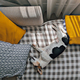 Jack Russell, senior dog, is napping on sofa with yellow pillows and plaid - PhotoDune Item for Sale