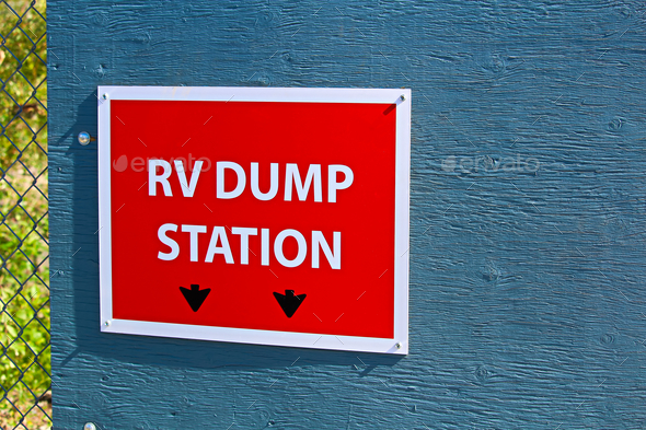 An RV dump station sign on the edge of a building