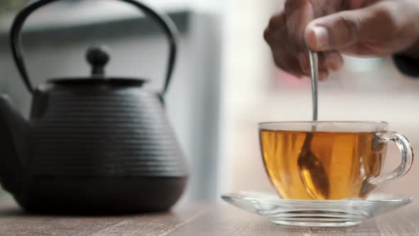 African American Man Drinking Tea in the Restaurant alt