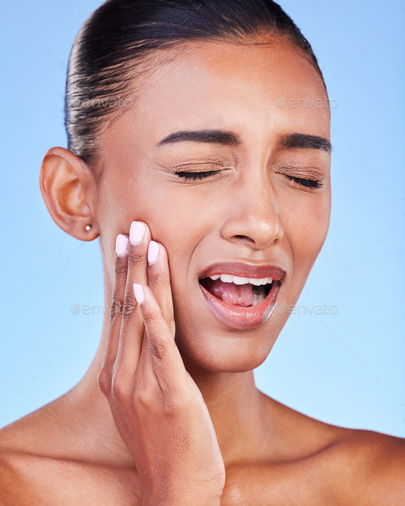 Toothache, cavity and a woman with mouth pain on a blue background with a dental emergency. Dentist