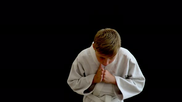 A Young Man in a White Kimono Stands in a Welcoming Pose alt