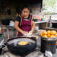 Adult latin woman preparing food in a rural kitchen - PhotoDune Item for Sale