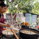 Latin woman preparing food on an outdoors rural kitchen - PhotoDune Item for Sale