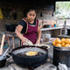 Latin woman frying food in pans in a rural kitchen - PhotoDune Item for Sale