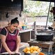 Vertical photo of a woman frying food in a rural kitchen - PhotoDune Item for Sale