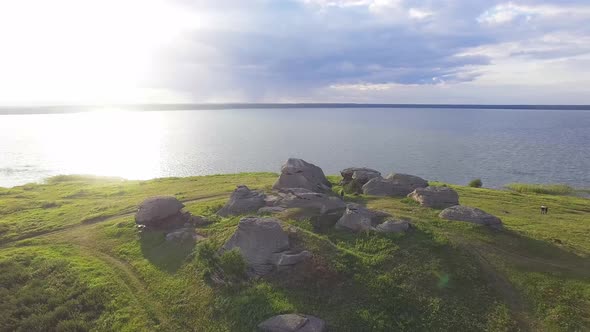 Aerial view of Huge stones (rocks) in a vast field by the lake 06 alt