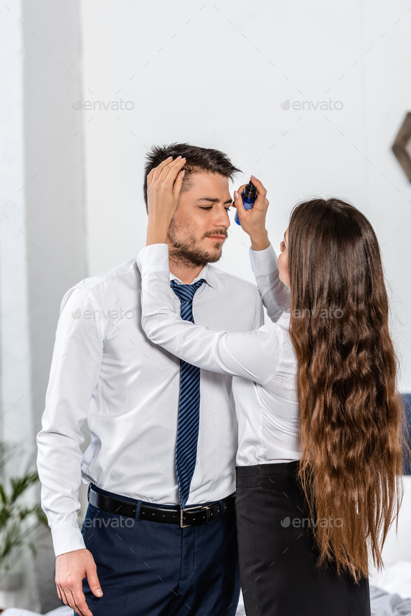 girlfriend styling boyfriend hair in morning at home, social role concept