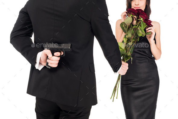 back view of man gifting red roses while hiding gun behind the back, isolated on white
