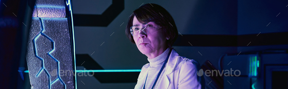 future science, serious middle aged woman scientist in futuristic neon-lit technology hub, banner
