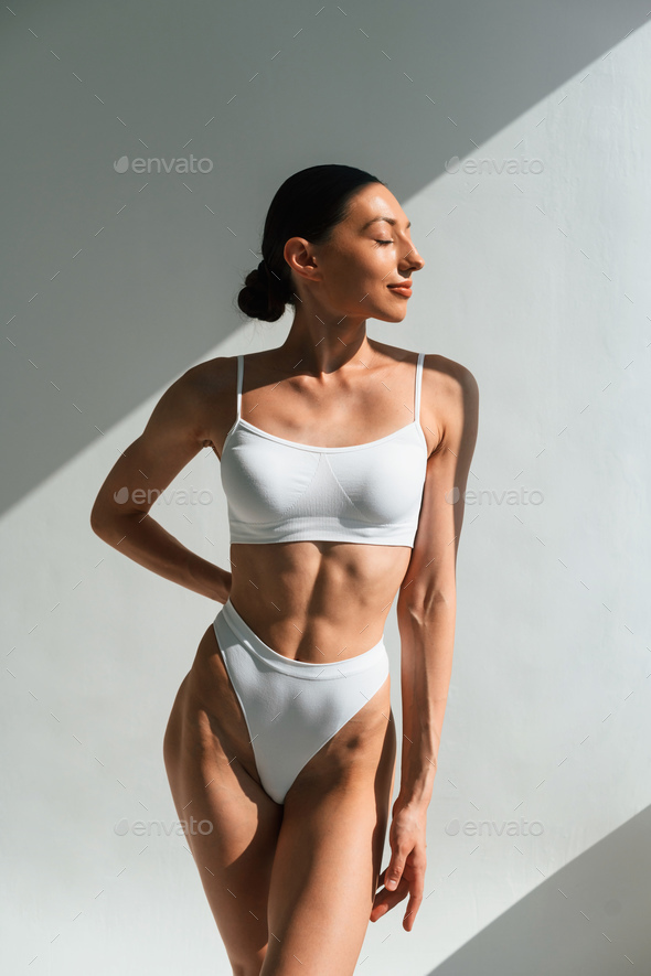 Fashion model. Woman in underwear with slim body type is posing in