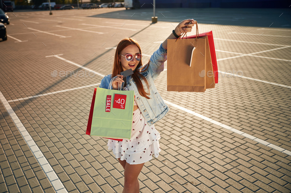 woman in casual clothing with shopping bags Stock Photo by