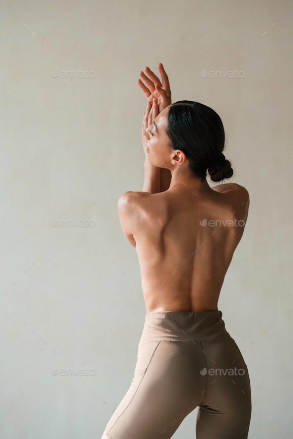 Doing exercises for the spine. Young woman in underwear is in the studio  Stock Photo by mstandret