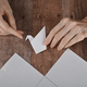 hands of an elderly woman fold origami paper. Creating an origami paper crane - PhotoDune Item for Sale