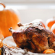 Delicious golden roasted Thanksgiving turkey on dinner table with pumpkins - PhotoDune Item for Sale