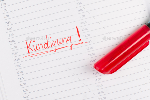Termination is standing in german language in a calendar, red color and pen, fired from job