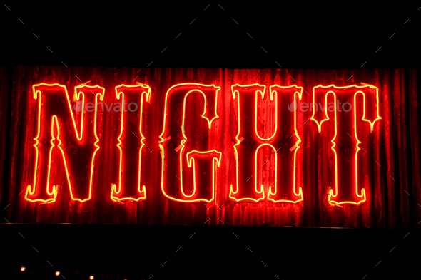 Closeup shot of red neon lights with writing \'NIGHT\'
