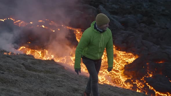 Smiling Man By Lava Flow From Erupting Fagradalsfjall Volcano In Iceland alt