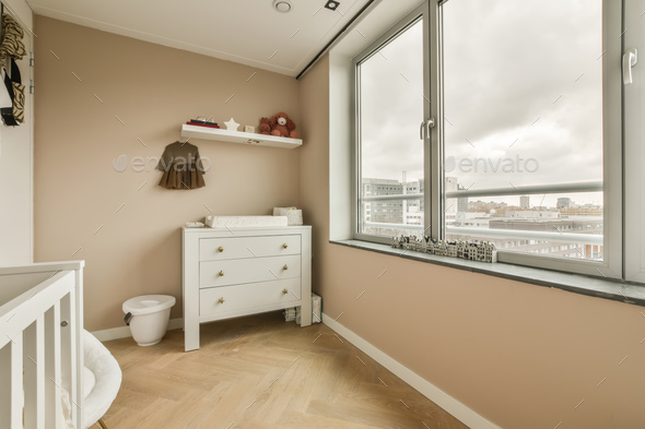 a bathroom with a large window and a dresser