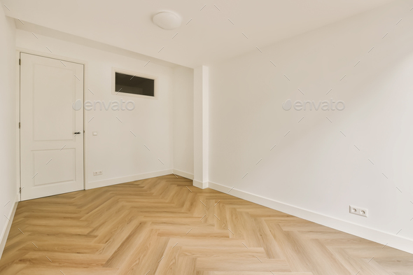 a room with a wooden floor and a white door